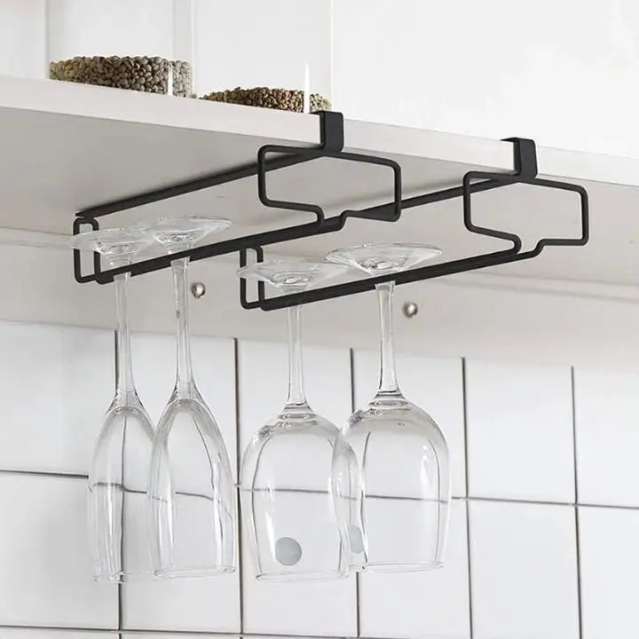 Undercabinet metal wine glass holder storing hanging wine glasses in a kitchen