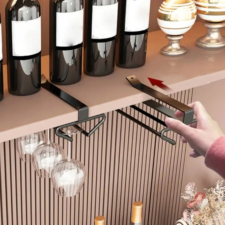 Undercabinet metal wine glass holder storing hanging wine glasses in a kitchen