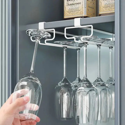 Undercabinet metal wine glass holder storing hanging wine glasses in a kitchen