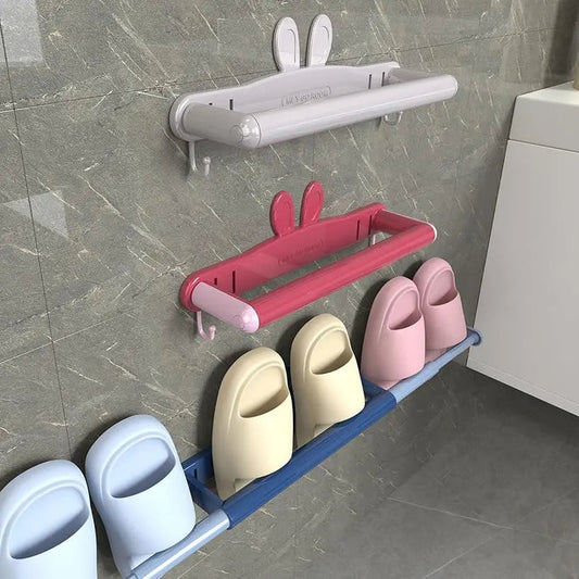 Wall-mounted metal shoe rack holding multiple pairs of shoes in a hallway