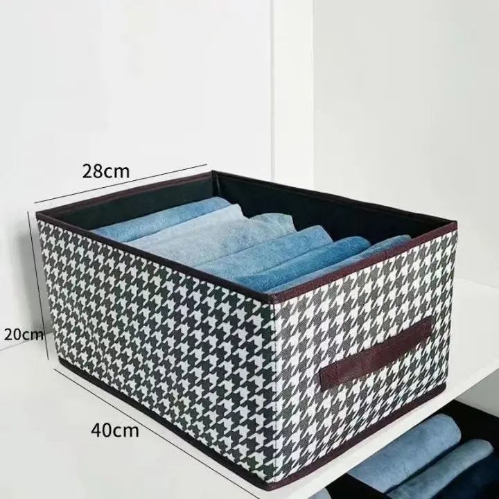 Foldable brown wardrobe organiser with reinforced sides and handles for storing folded clothes on wardrobe shelves
