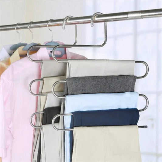 Space-saving pants hanger holding multiple trousers
